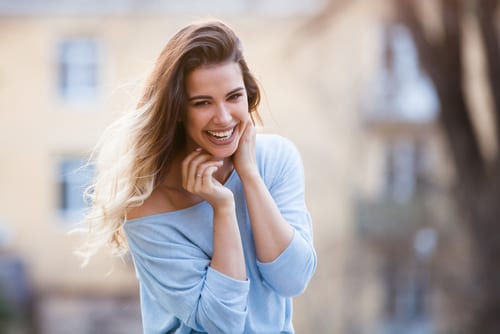 Outdoors portrait of beautiful young girl laughing-img-blog