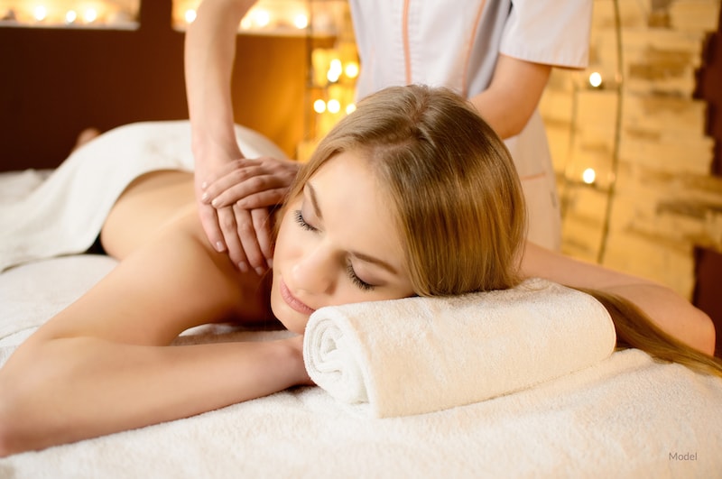 A woman receiving a back massage