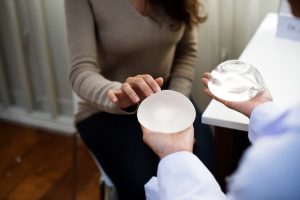 A woman choosing her breast implant type.