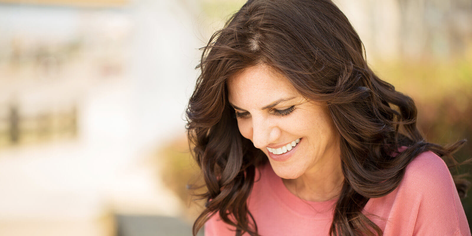 Mature smiling woman looking down