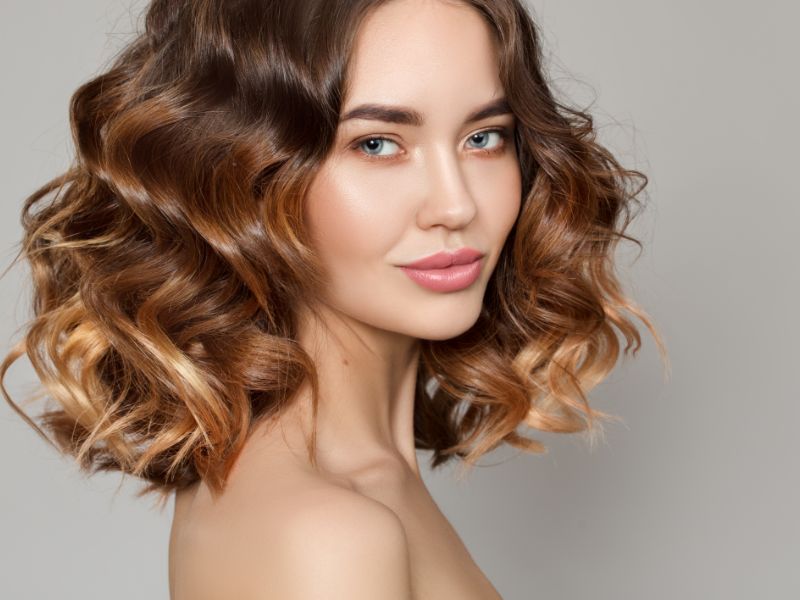 Young woman with wavy hair smiling