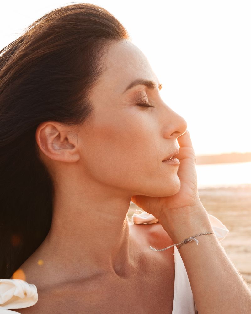 Profile of a beautiful woman at the beach